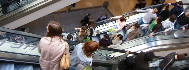 people out shopping on escalator